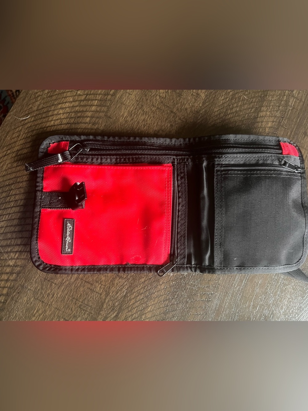 Eddie Bauer Black Exterior with Bright Red Interior Wallet. Travel wallet